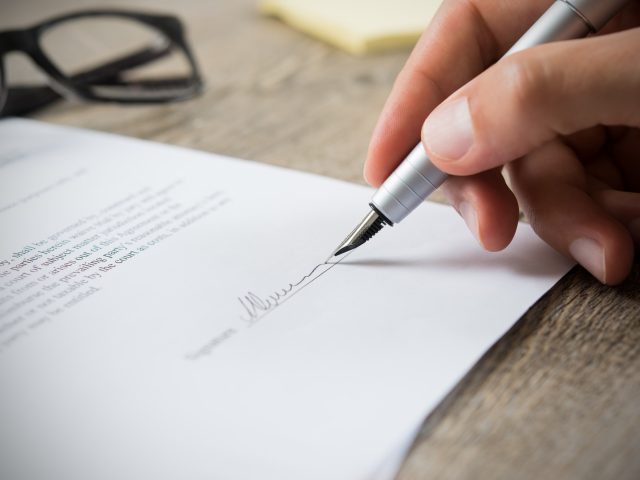 Man signing contract Man signing contract
